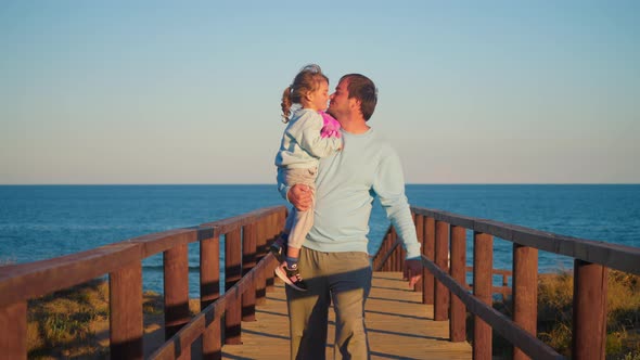 VideoHive A Happy Father Carries His Little Daughter in His Arms and Kisses Her Happy Fatherhood Happy 50413131